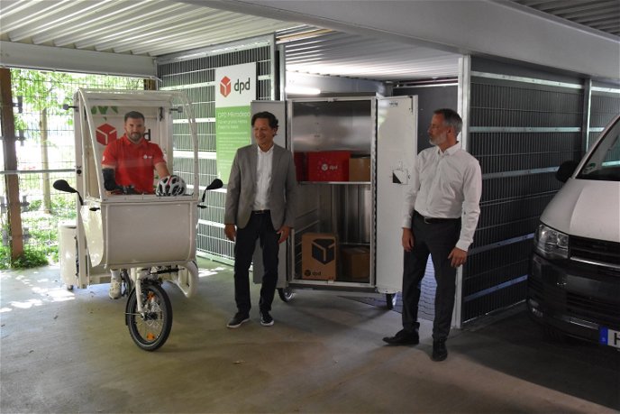 Gerd Seber, Verantwortlicher von DPD, und Markus Henrich, Geschäftsführer der Hanau Parkhaus GmbH (von rechts), gaben den offiziellen Startschuss für den Lastenrad-Mikrohub im Parkhaus am Heinrich-Fischer-Bad